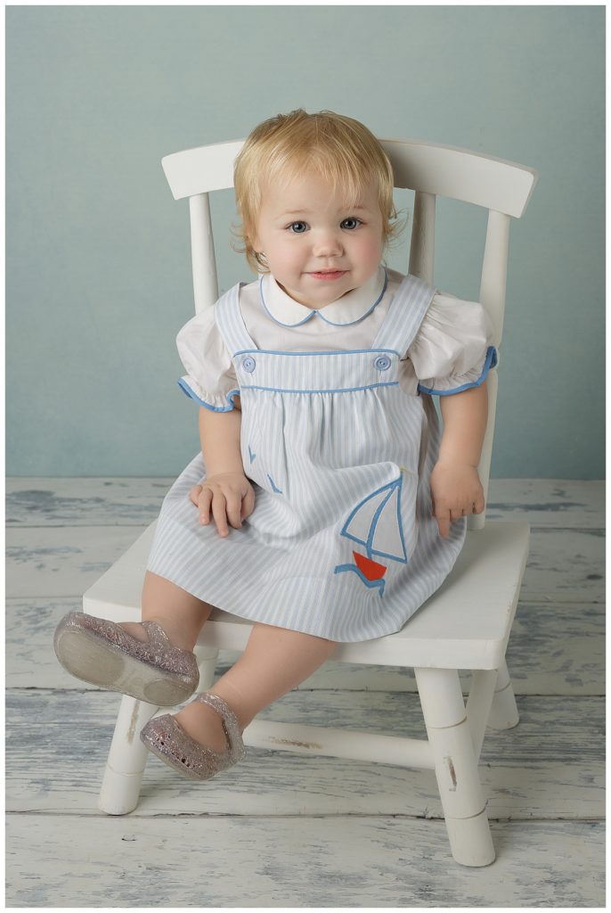 Blonde Baby girl in White Rocking Chair